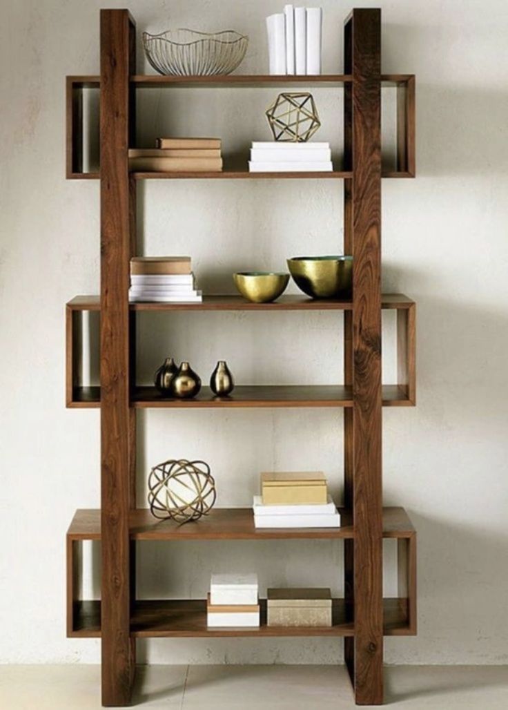 a wooden shelf with books and bowls on it