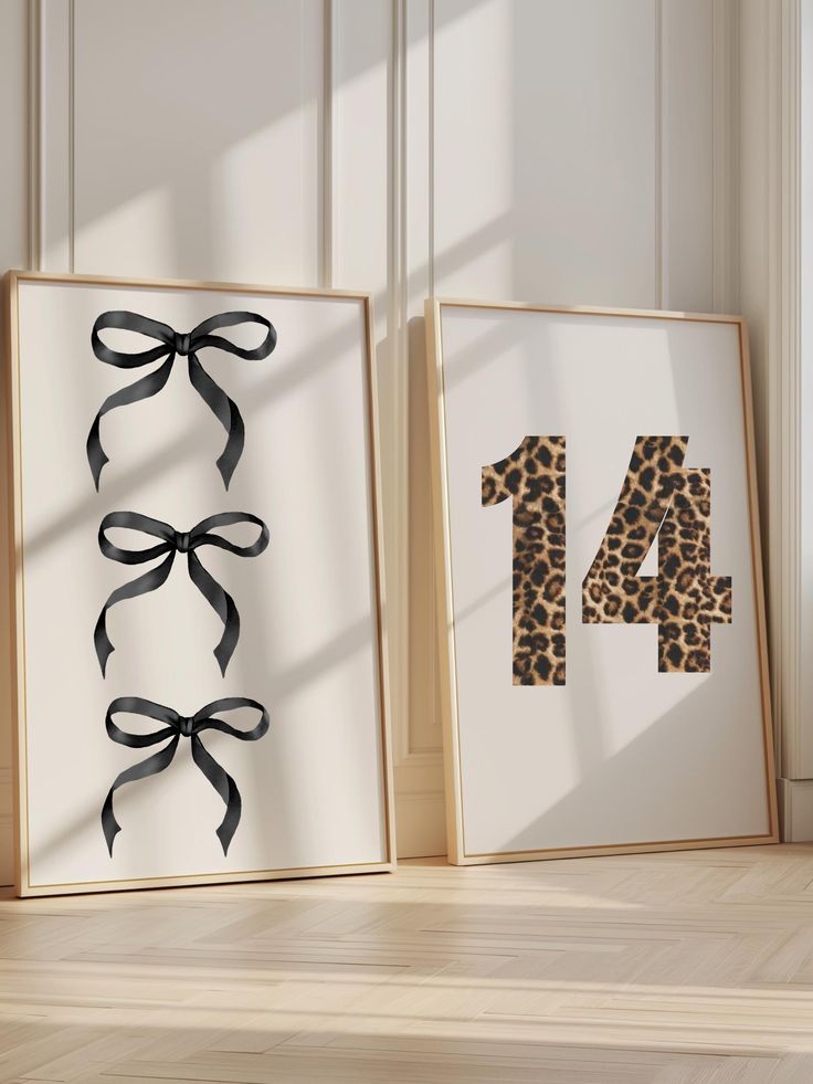 two framed art pieces with black ribbons on them