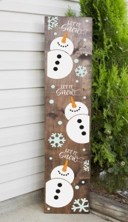 a wooden sign that has snowmen on it