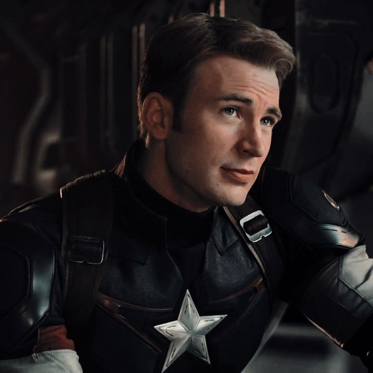 a man dressed as captain america in a scene from the avengers movie, with his hands on his hips