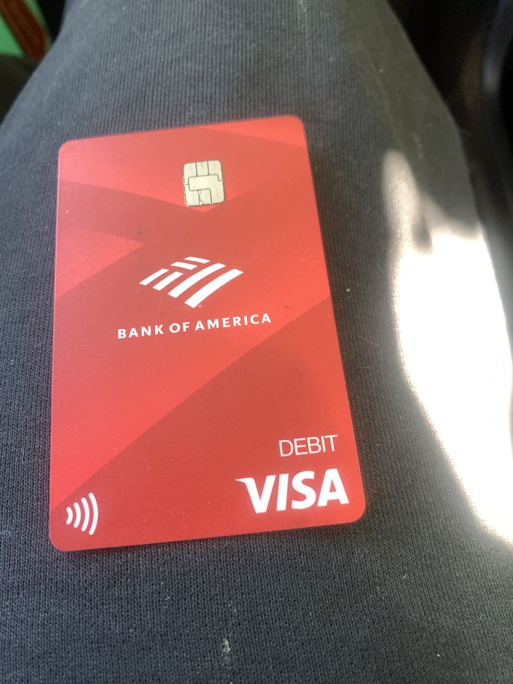 a red credit card sitting on top of a seat