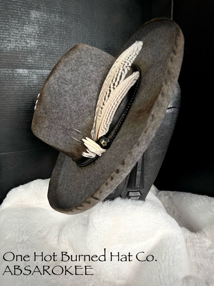 "One Hot Burned Hat Co. Introduces ABSAROKEE. A beautiful wool custom burned rancher hat. Hand stitched with custom beads. Truly a one of a kind. The outside dimensions are 15\" L x 14 1/2\" W  The inside dimensions are 7 3/4\" L x 6 1/2\" Wit comes with an inner adjustable liner." Bohemian Wool Felt Hat With Short Brim, Bohemian Wool Hat With Flat Brim, Rustic Felt Hat With Curved Brim For Winter, Rustic Curved Brim Felt Hat For Winter, Artisan Short Brim Felt Hat For Fall, Artisan Felt Hat With Short Brim For Fall, Bohemian Wool Hat Bands For Brimmed Hats, Bohemian Wool Fedora Felt Hat, Bohemian Wool Brimmed Hat Bands