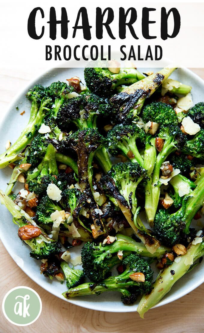 broccoli salad on a white plate topped with nuts