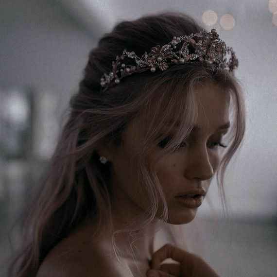 a woman with long hair wearing a tiara