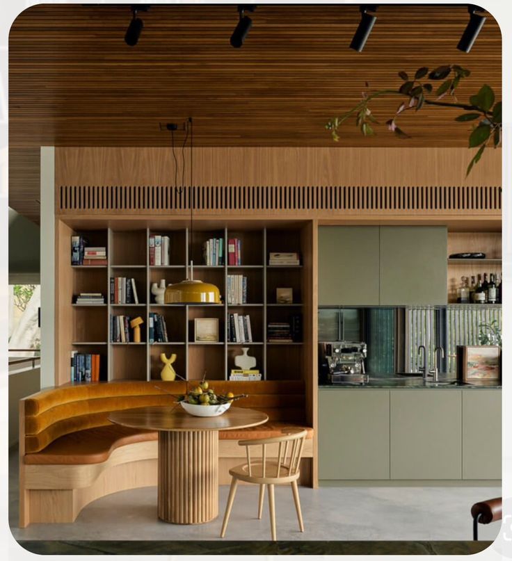 a wooden table sitting in front of a bookshelf