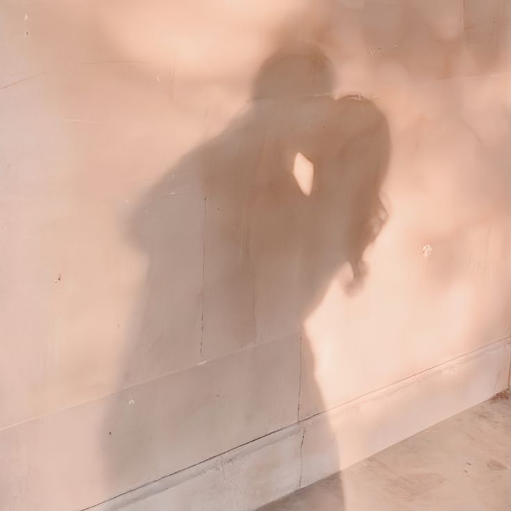 the shadow of a person standing against a wall