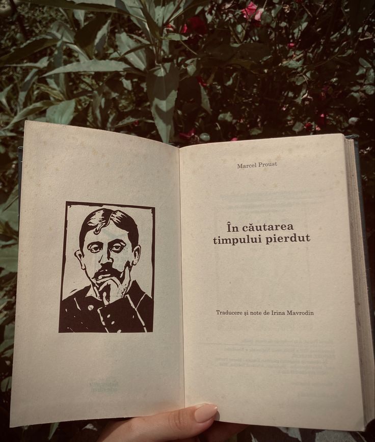 a person holding an open book in front of some trees and bushes, with the title la cauaurara imppuu picaut