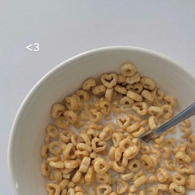 a bowl full of cereal with a spoon in it