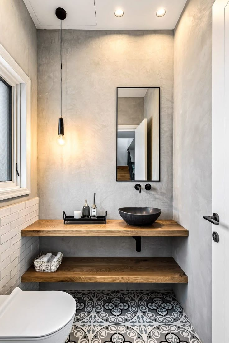 a bathroom with a sink, mirror and toilet