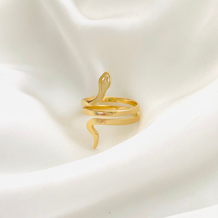 ⭐️Item Details: Ring Height: 25mm Material: 18k Gold Filled Benefits: Water & Tarnish Resistant, Hypoallergenic, Lightweight ⭐️Care Instructions: 1. You may shower and sleep with your gold filled items but it is highly suggested to avoid direct contact with pools, hot tubs, and saltwater. 2. Avoid the jewelry to come into contact with perfume, lotions or any other cosmetic products. 3. Rinse jewelry in warm water at least once a week and gently dry it with a soft cotton cloth to ensure durabilit Adjustable Gold Snake Ring Gift, Gold Snake Shape Rings For Anniversary, Gold Snake Ring As Gift, Gold Plated Snake Ring As A Gift, Adjustable Gold Snake Ring Symbolic, Adjustable Gold Symbolic Snake Ring, Gold Plated Snake Ring Gift, Gold Minimalist Snake Ring For Gift, Minimalist Snake Ring As A Gift