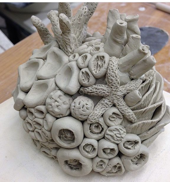 a sculpture made out of clay on top of a table