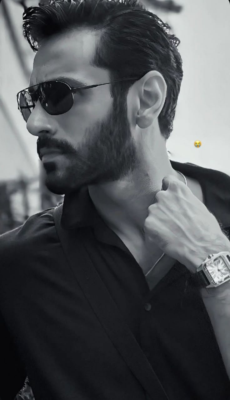 a man with sunglasses and a watch on his wrist