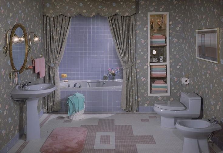 the bathroom is decorated in pastel colors and has pink rugs on the floor