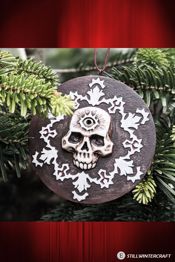 a skull ornament hanging from a christmas tree