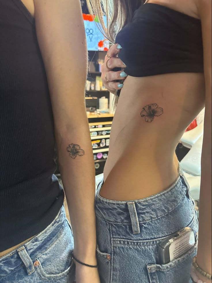 two women with tattoos on their stomachs