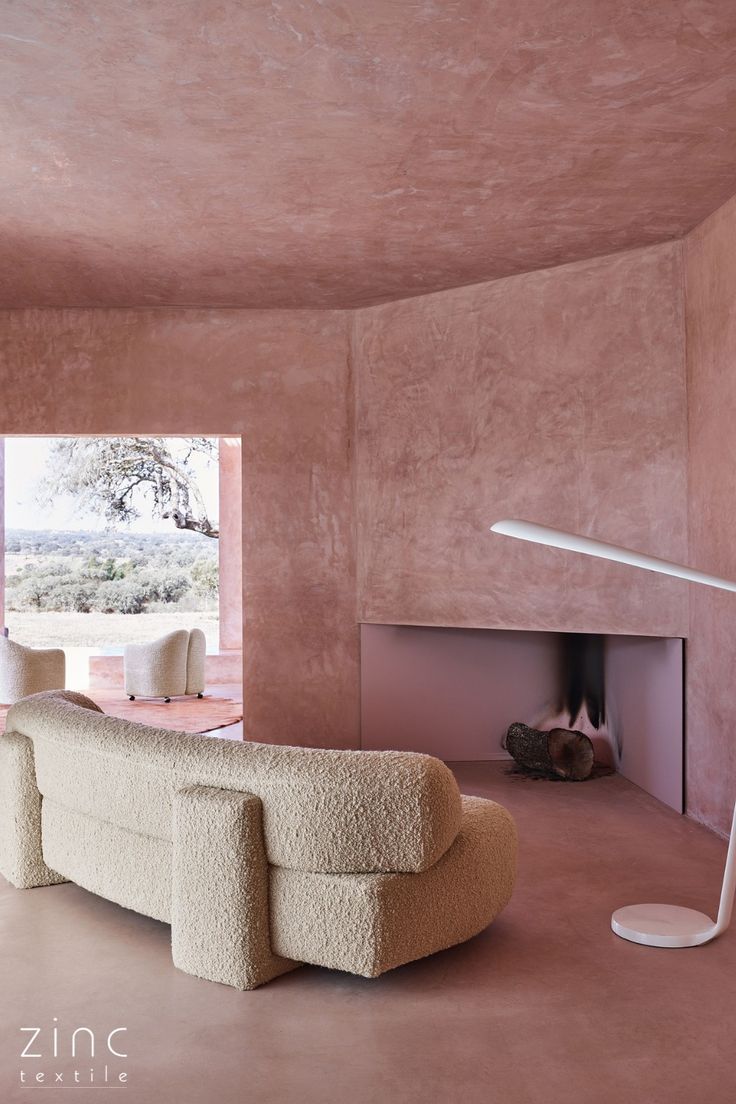 A portuguese villa with pink limewash walls featuring a curved contemporary sofa upholstered in a highly textured cream bouclé weave Gogan Sofa, Limewash Walls, Limewash Paint, Modernist Architecture, Paint White, White Sofa, Pink House, White Sofas, Pink Houses