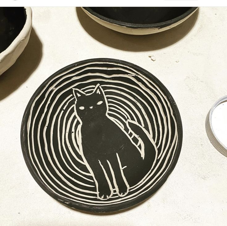 a black and white plate with a cat on it