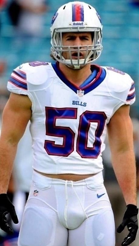 a close up of a football player wearing a helmet and uniform with his hands on his hips