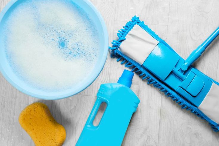 a blue dust mop next to a yellow sponge