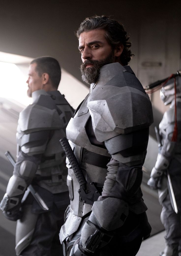 two men dressed in futuristic armor standing next to each other