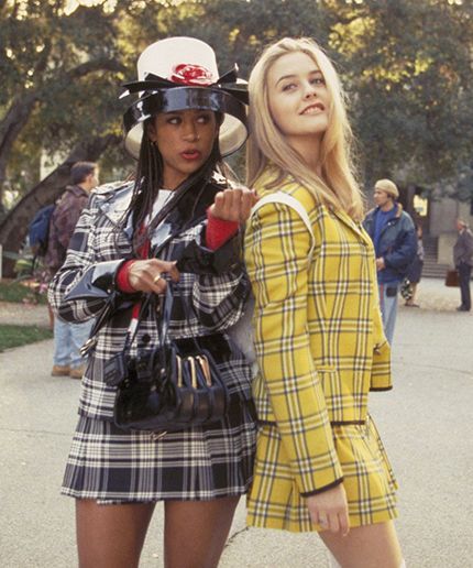 two women in plaid outfits walking down the street