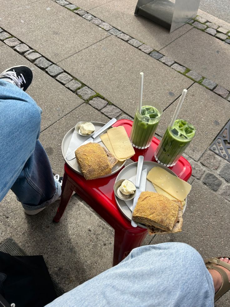 two people sitting at a table with food on it