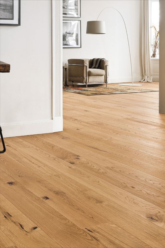 a living room with hard wood floors and white walls