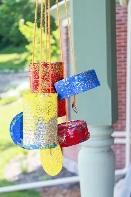 a colorful wind chime hanging from a porch