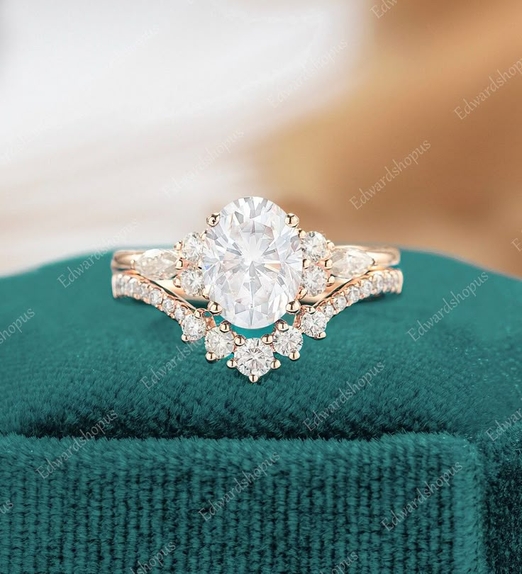 an engagement ring on top of a green velvet box with the diamond in the center