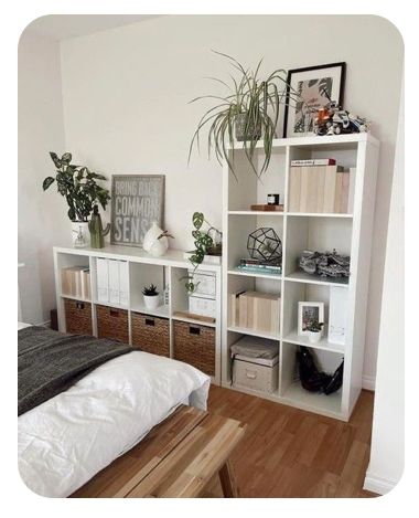 a bedroom with white shelving and plants on the wall above it, along with a bed