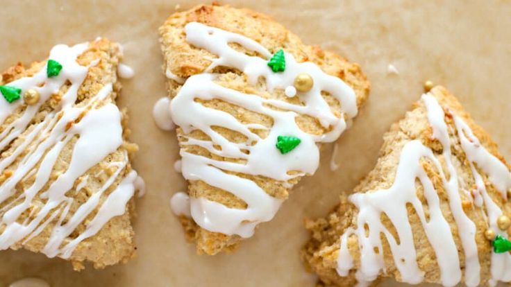 three scones with white icing and green sprinkles