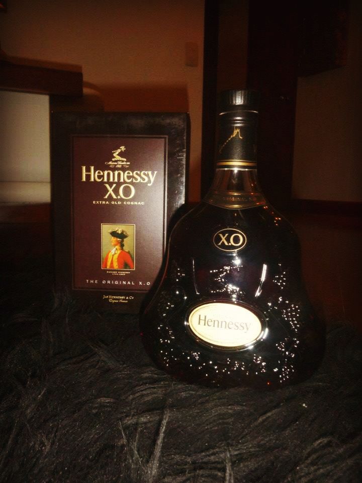 a bottle of hennessy xo next to a box