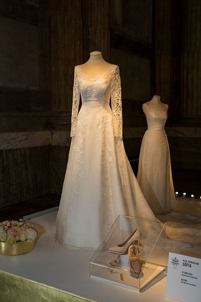 wedding gowns and shoes on display in a museum