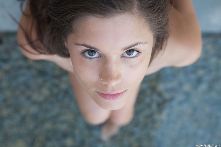 a woman with blue eyes looking up at the camera