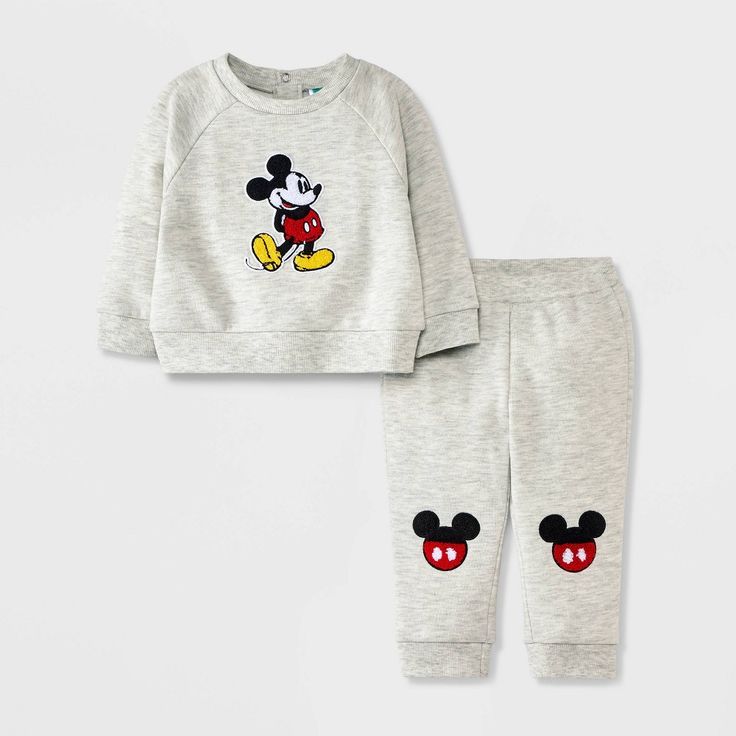 Your baby will look sweet and cozy wearing the Disney Mickey Mouse Chenille Patch Fleece Pullover and Pants Set. This gray outfit set includes a raglan-sleeve sweatshirt and a pair of jogger pants, both featuring Mickey chenille patches for an adorable look. The sweatshirt's back snaps make on-and-off easy, while the full elastic waistband helps keep the joggers in place. Crafted from midweight fabric, the pieces help keep your little one comfortable and are fun to mix and match with other cloth Disney Baby Clothes Boy, Mickey Mouse Gifts, Disney Baby Clothes, Raglan Sleeve Sweatshirt, Chenille Patch, Newborn Boy Clothes, Grey Outfit, Boys Sweatshirts, One Clothing