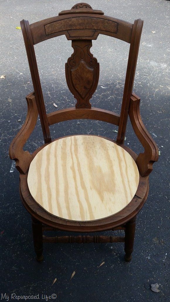 a wooden chair sitting on top of a black floor