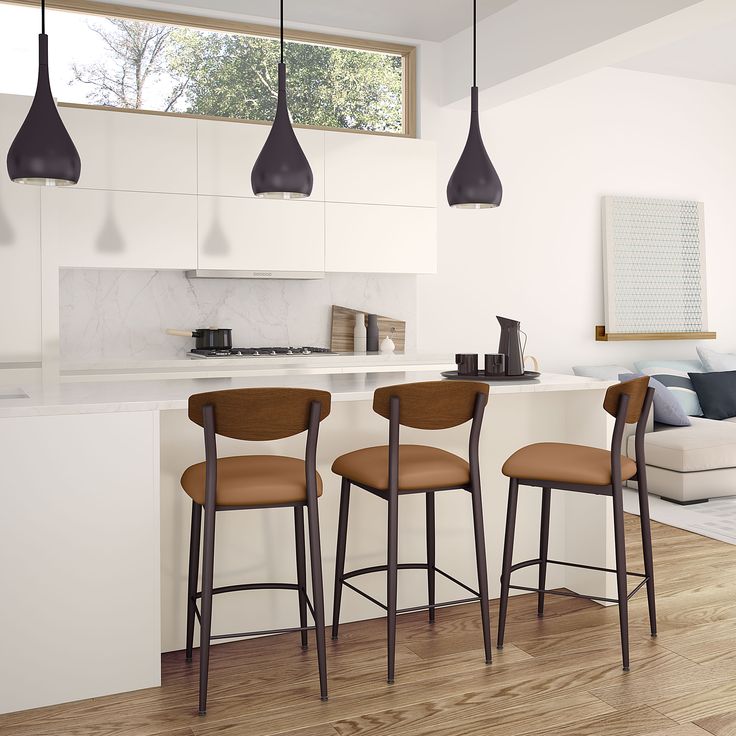 three bar stools sit in front of a kitchen island