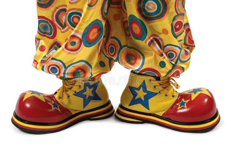 clown's legs and shoes with colorful circles on them, against a white background