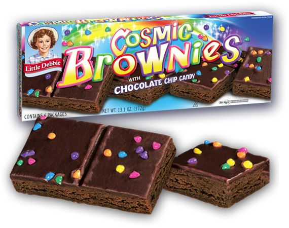 a box of chocolate brownies with confetti on the top and candy in the middle