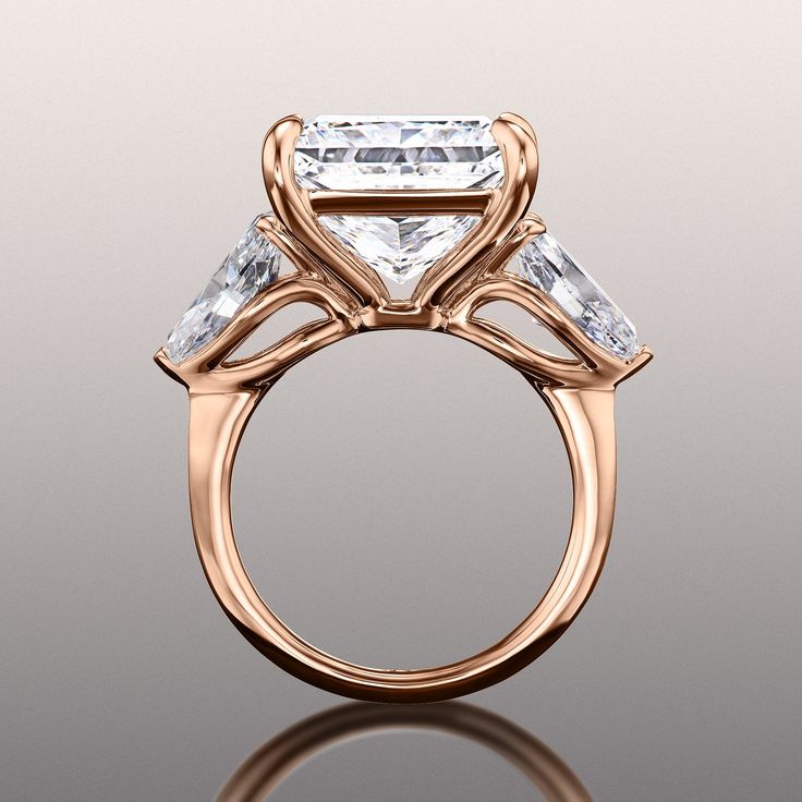 an engagement ring with three stones on the side and a center stone in the middle