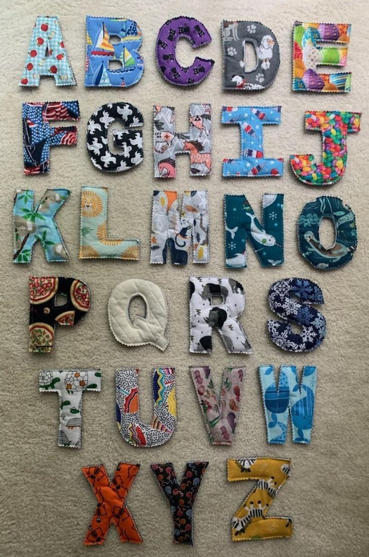 the letters are made up of different fabrics and materials to make it look like they are