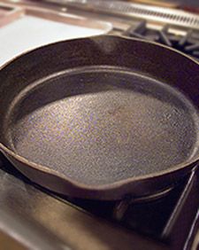 a frying pan sitting on top of a stove next to an oven burner