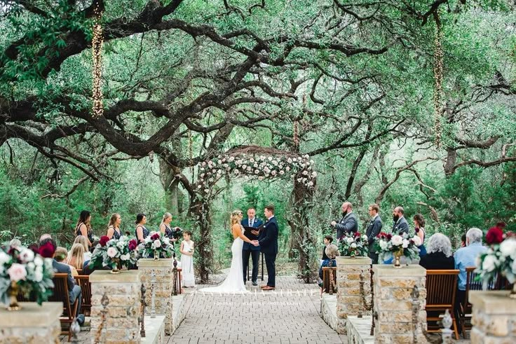 a couple getting married under an oak tree