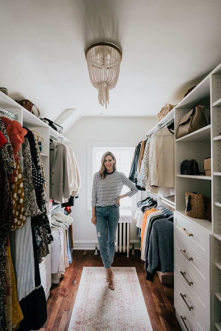 a woman standing in the middle of a closet