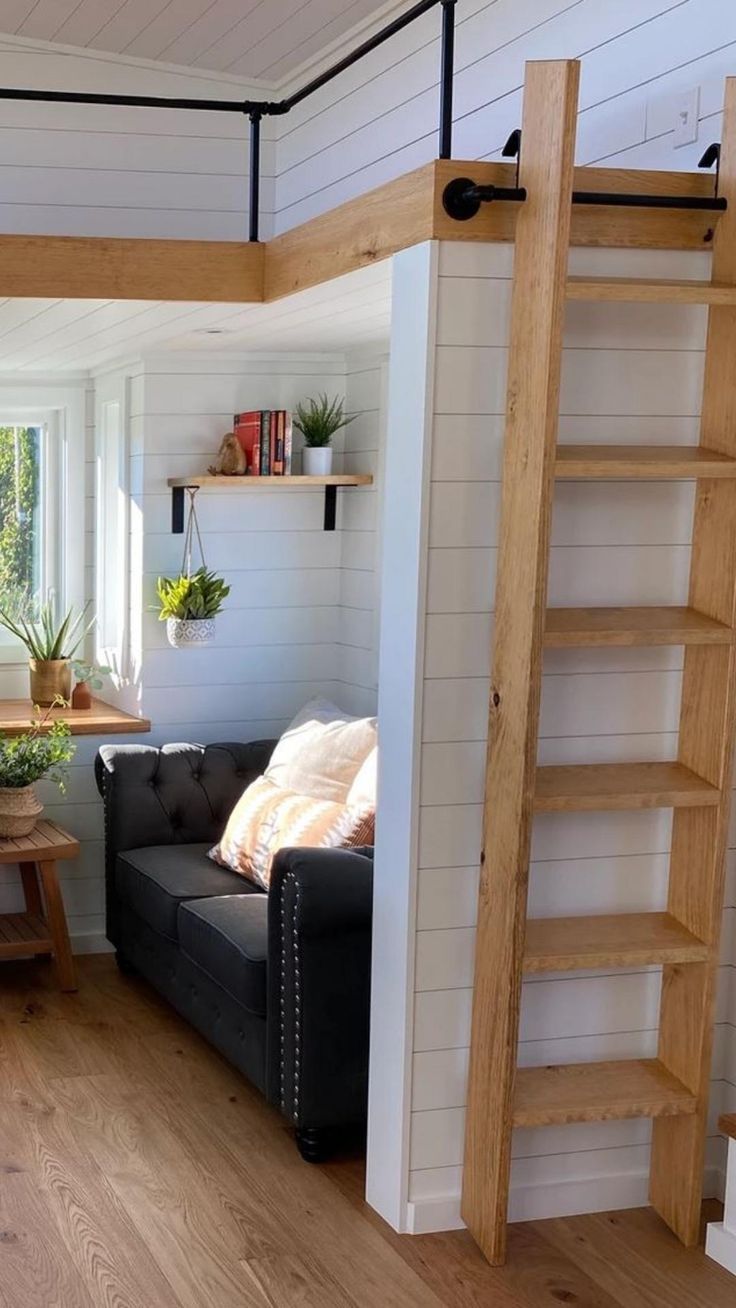 a living room with a couch, table and ladder