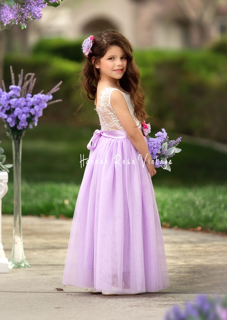 Dress your little one in elegance with our Lavender Sleeveless Tulle Flower Girl Dress! Featuring a soft white lace bodice and flowing lavender tulle skirt, it pairs perfectly with our matching bridal accessories for Romantic, Shabby Chic, Vintage, Modern, and Classic Wedding Themes. Ideal for portraits and parties. How to Order: Dresses are true to size. Please measure to ensure best fit. *Select your preferred sash style and then leave the sash color in the cart notes at checkout. Additional O Spring Flower Girl Dresses, Flower Girl Dresses Purple, Lavender Flower Girl, Lavender Flower Girl Dress, Bohemian Flower Girl Dress, Dance Portraits, Burgundy Flower Girl Dress, Purple Flower Girls, Vintage Flower Girls