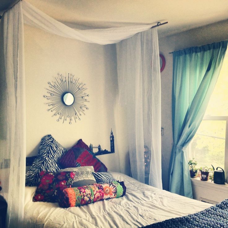 a bedroom with a canopy bed and blue drapes