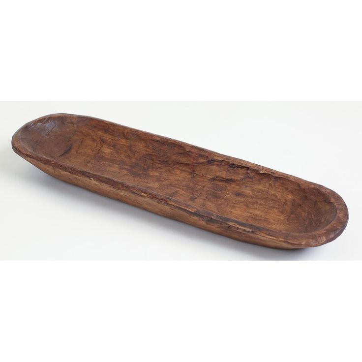 an old wooden spoon sitting on top of a white table