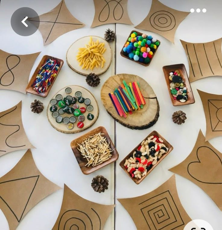 a table topped with paper plates filled with different types of food and crafts on top of it