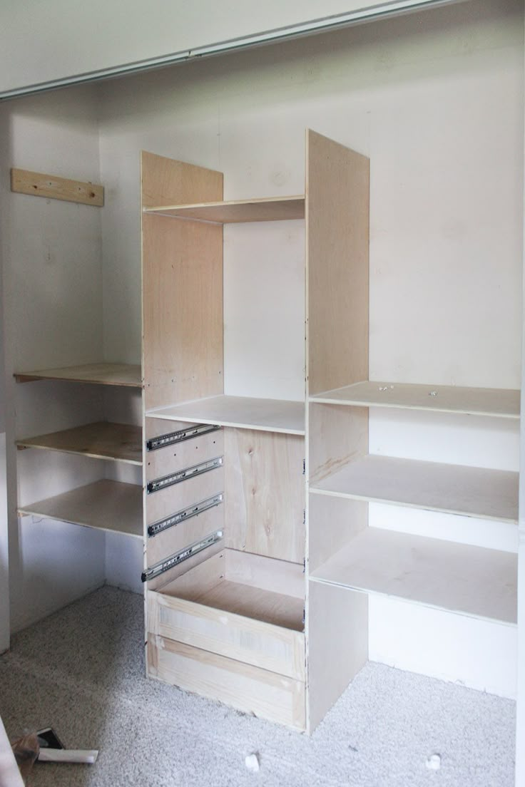 an empty room with shelves and drawers in it